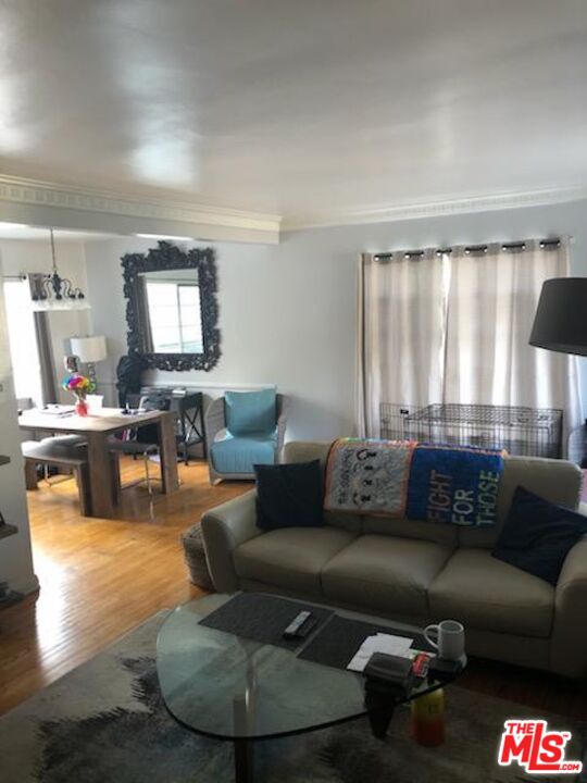 127 North Clark Drive Beverly Hills, CA 90211 - Photo 4 of 9 a living room with furniture and a large window