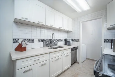 a kitchen with a sink and cabinets