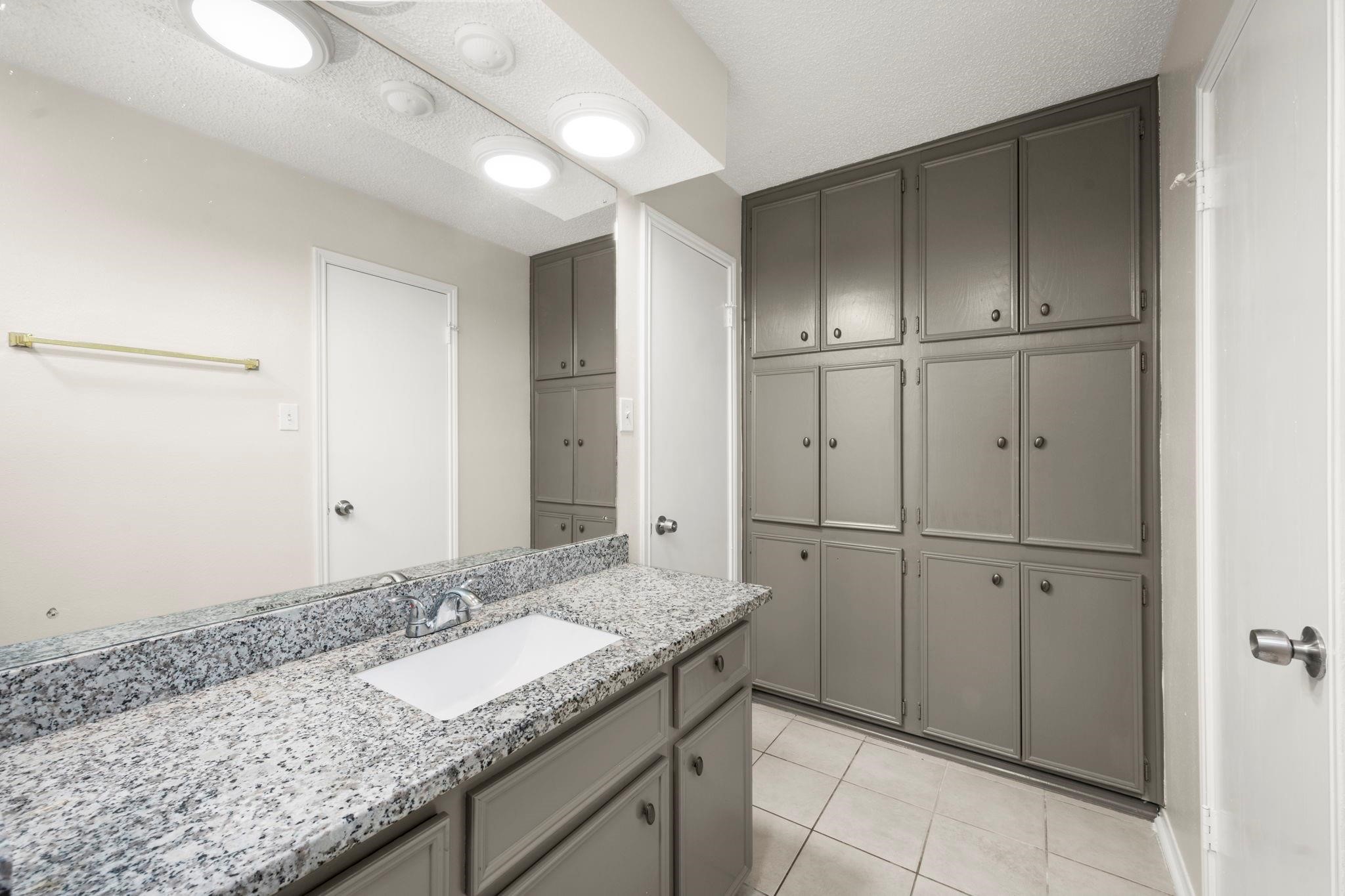 11718 Ridge Run Drive Houston, TX 77064 - Photo 16 of 17 a bathroom with a granite countertop sink and a mirror