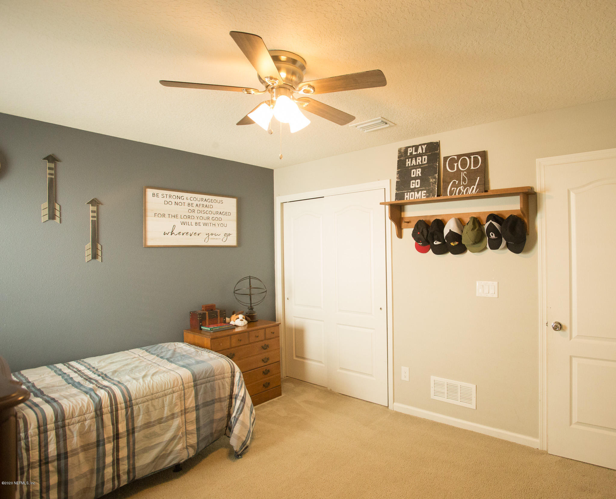 92 Bluejack Lane St. Augustine, FL 32095 - Photo 18 of 44 a bedroom with a bed and a chandelier