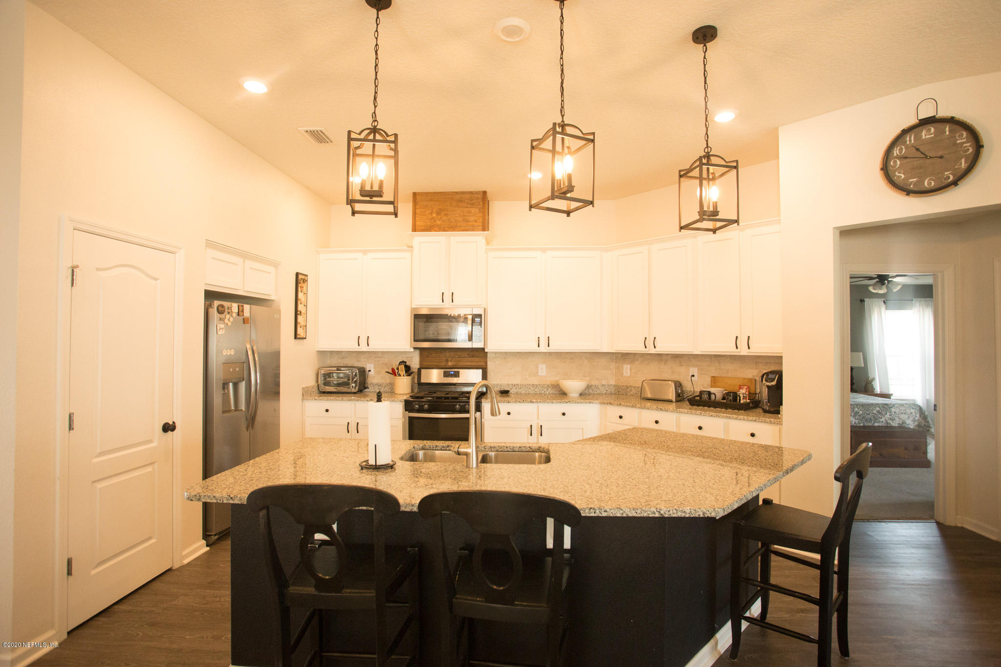 92 Bluejack Lane St. Augustine, FL 32095 - Photo 20 of 44 a dining room with stainless steel appliances kitchen island granite countertop a table chairs and a refrigerator