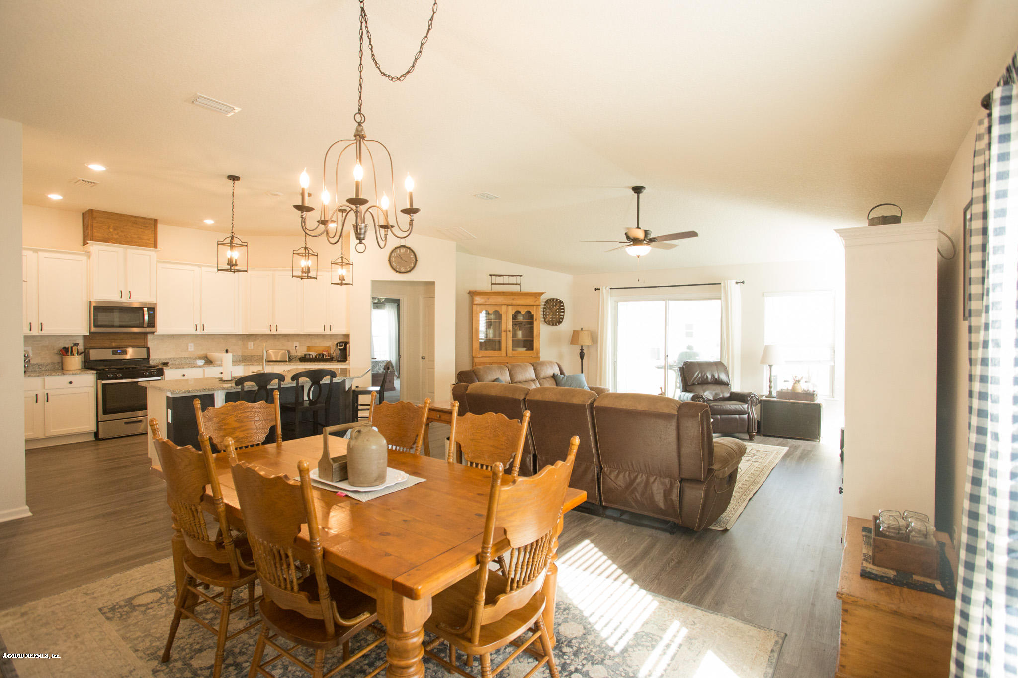 92 Bluejack Lane St. Augustine, FL 32095 - Photo 24 of 44 a view of a dining room with furniture wooden floor and chandelier
