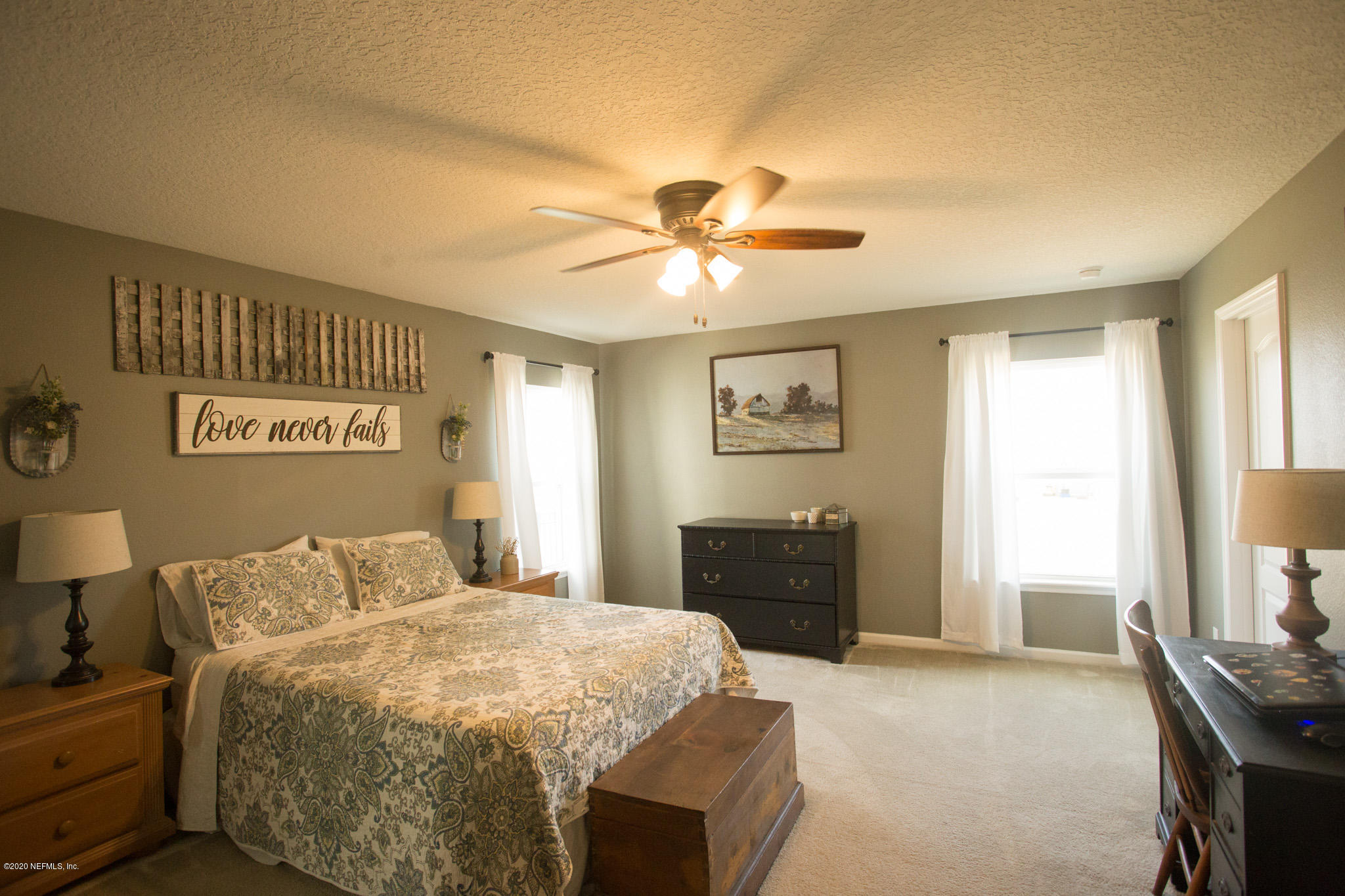 92 Bluejack Lane St. Augustine, FL 32095 - Photo 25 of 44 a bedroom with a bed and a chandelier