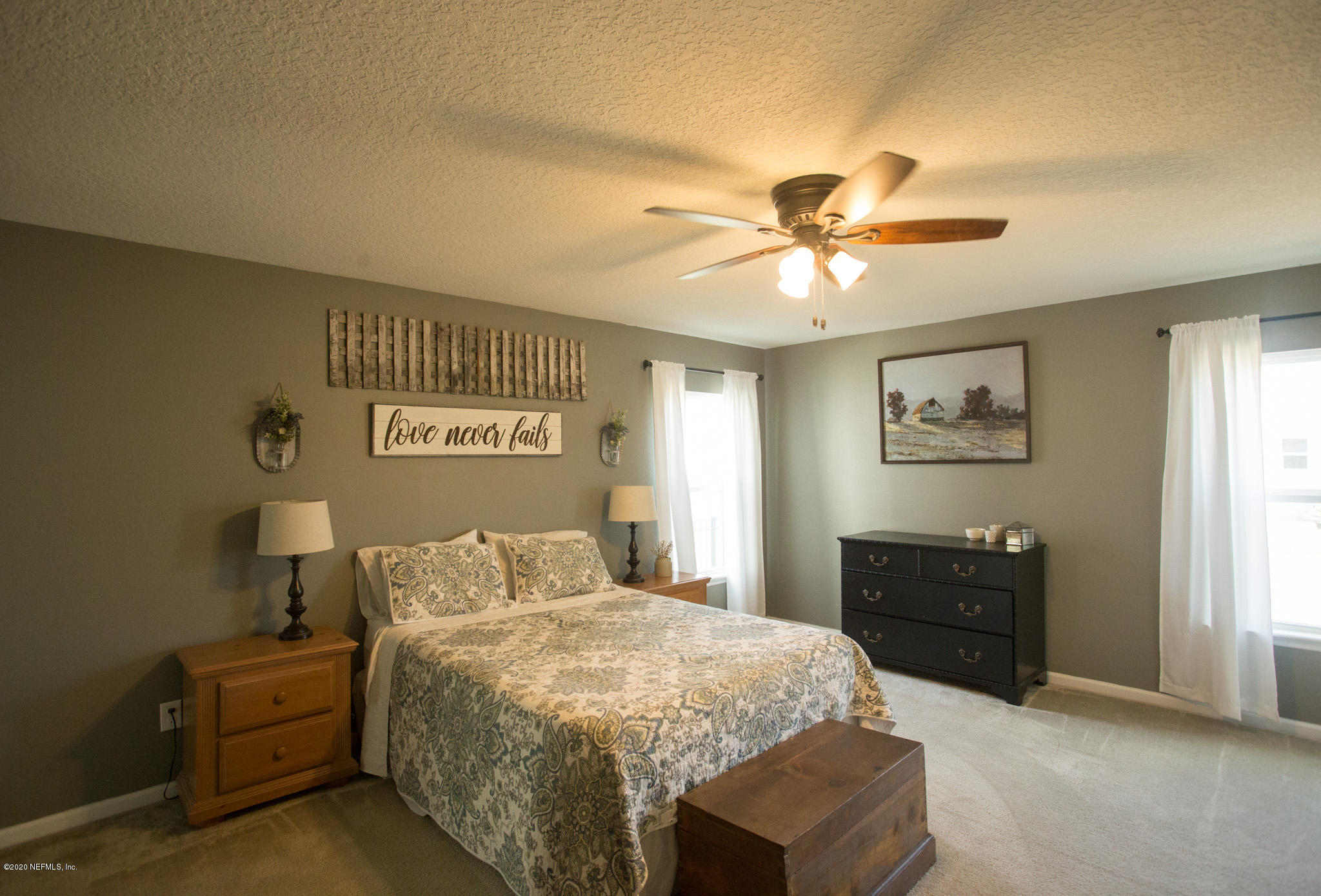 92 Bluejack Lane St. Augustine, FL 32095 - Photo 26 of 44 a bedroom with a bed and a chandelier