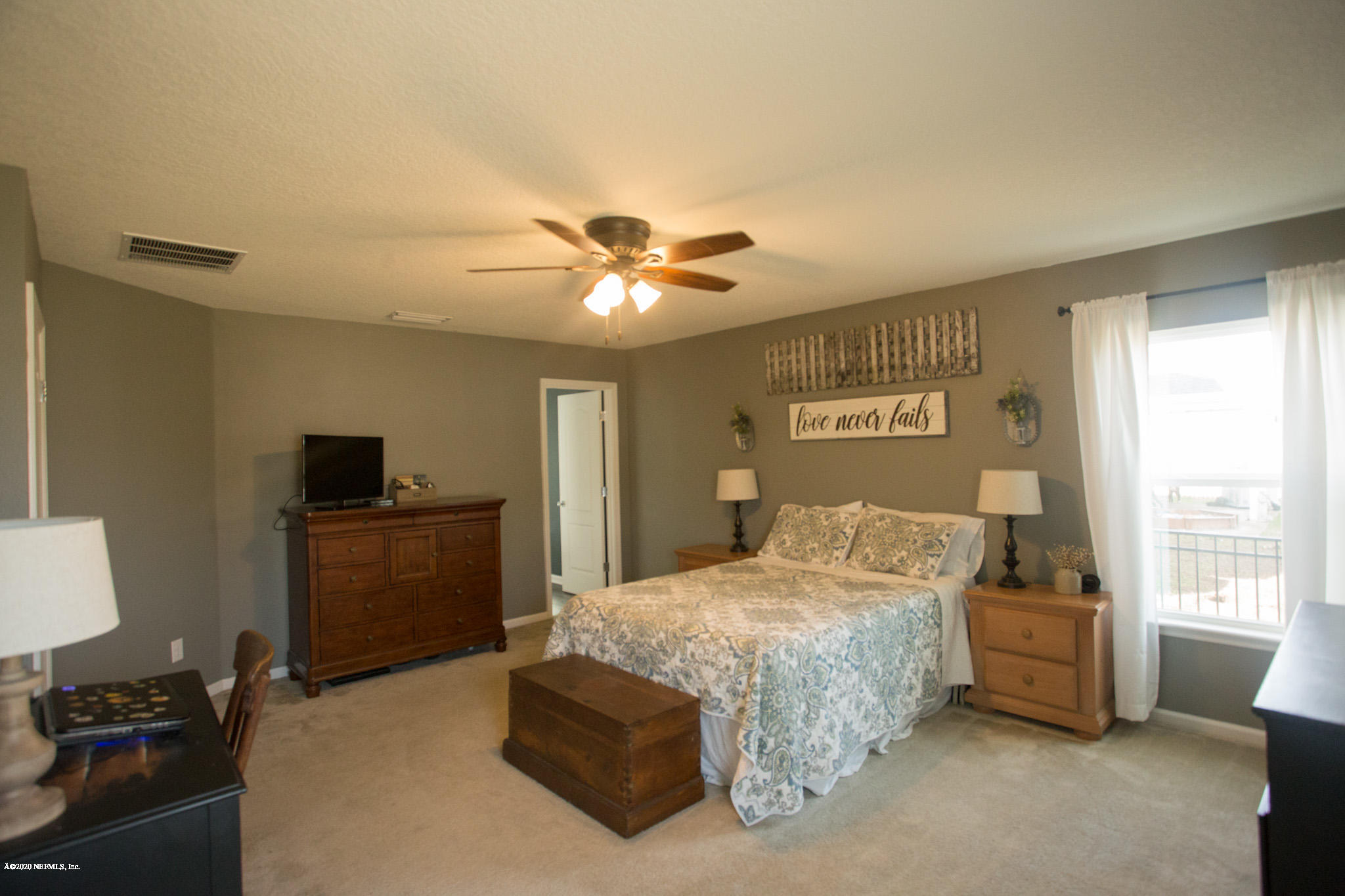 92 Bluejack Lane St. Augustine, FL 32095 - Photo 27 of 44 a bedroom with a bed and a tv