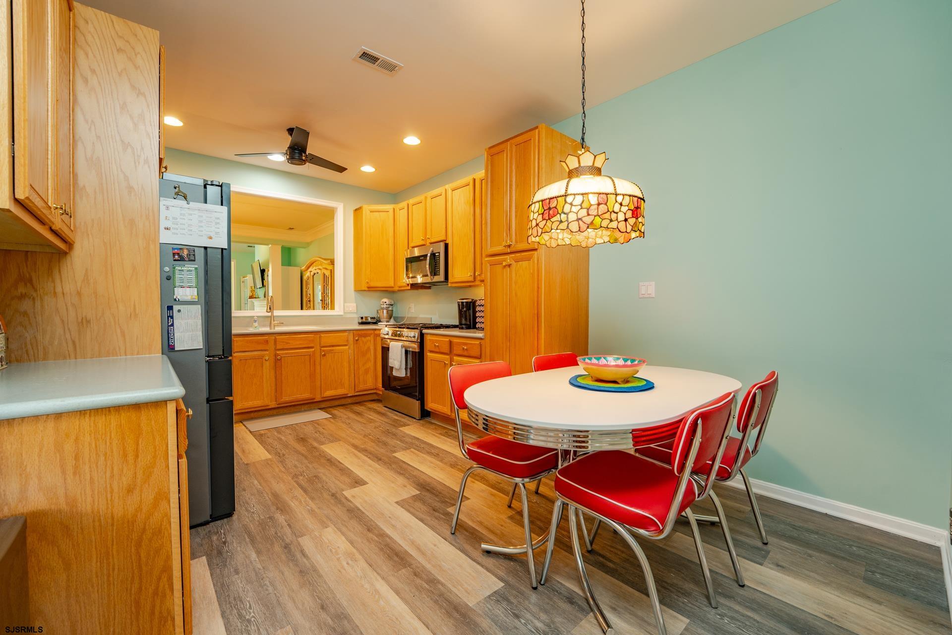 1731 Highway 9, Unit 28 Ocean View, NJ 08230 - Photo 18 of 41 a view of a dining room with furniture a chandelier and wooden floor