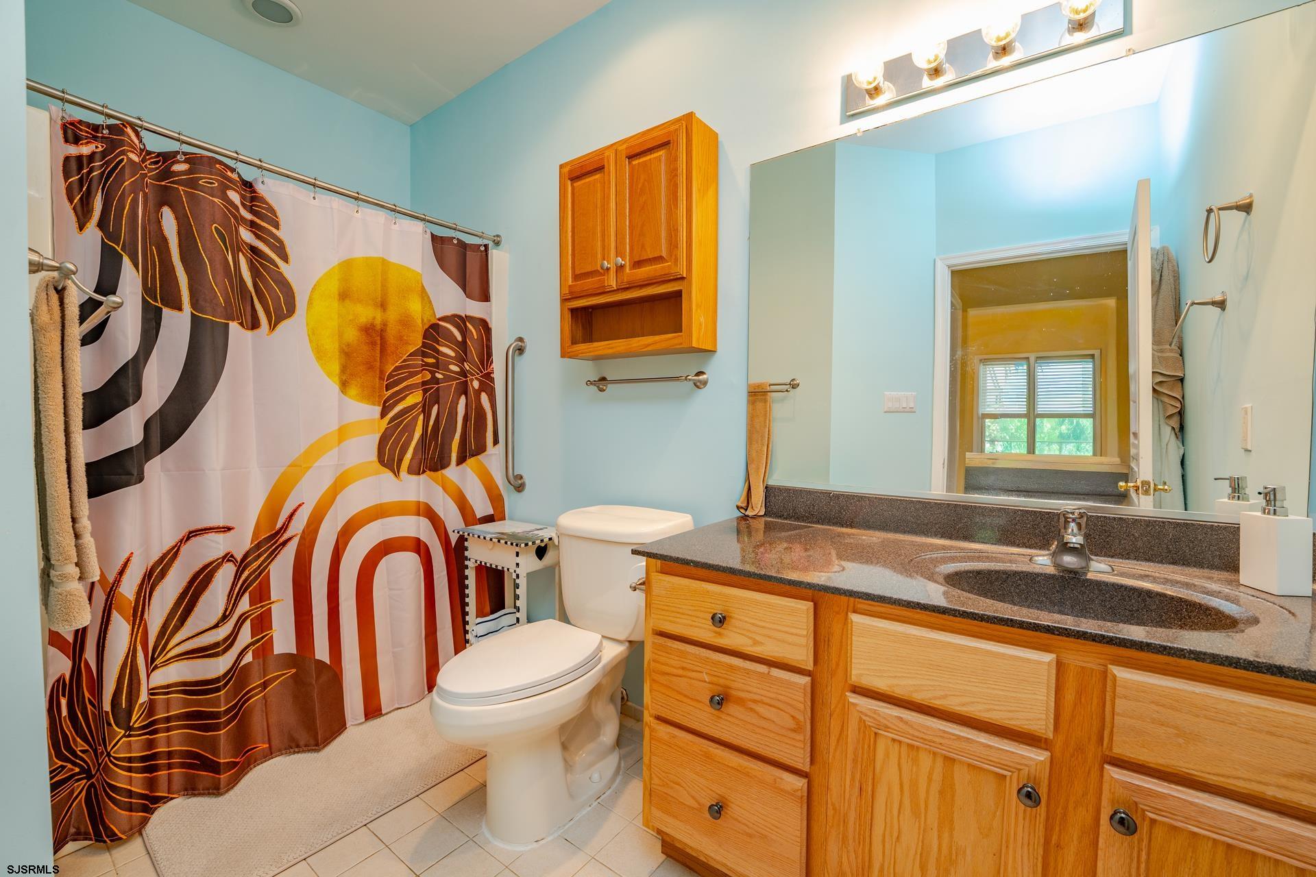 1731 Highway 9, Unit 28 Ocean View, NJ 08230 - Photo 22 of 41 a bathroom with a sink a mirror a toilet and a window