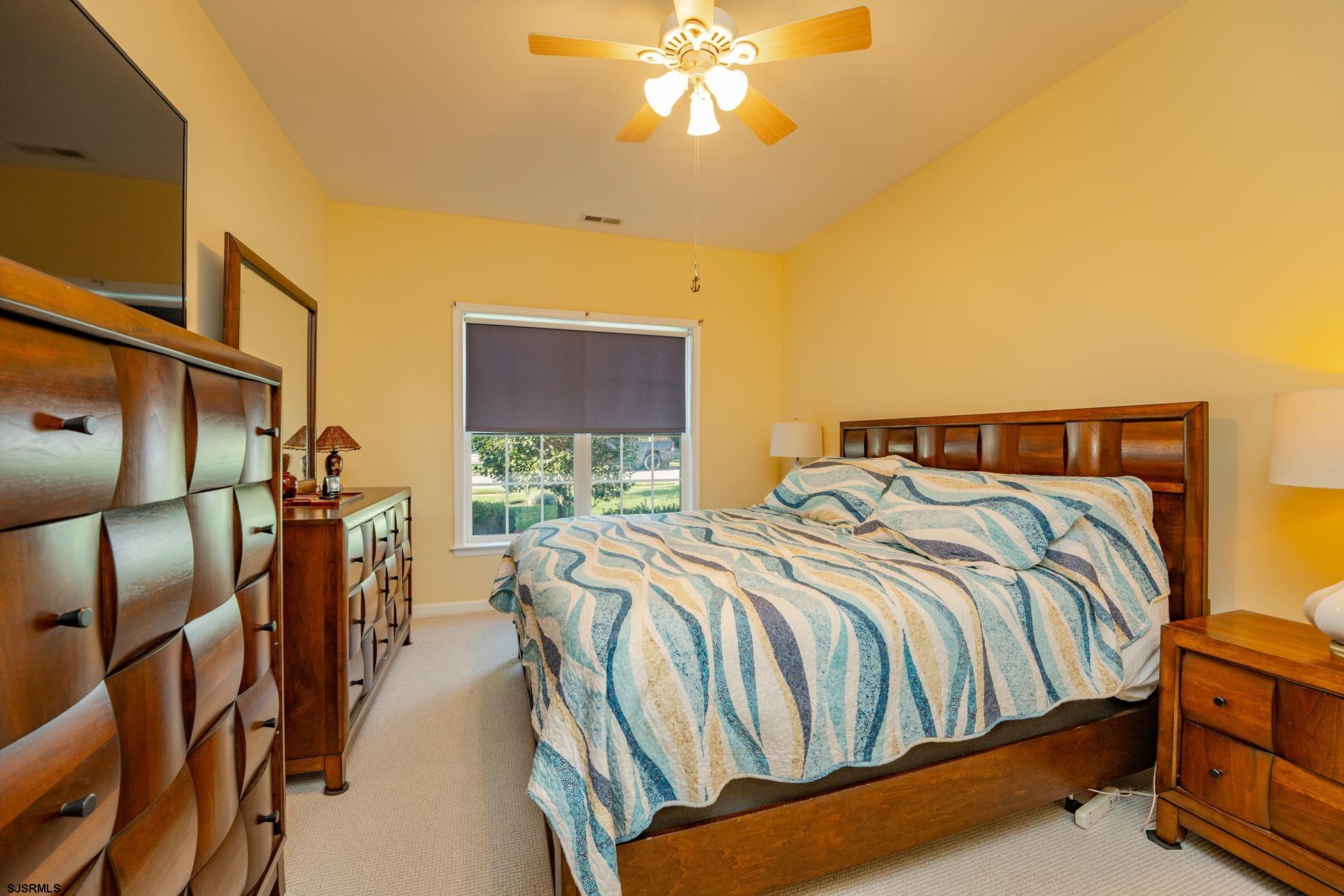 1731 Highway 9, Unit 28 Ocean View, NJ 08230 - Photo 24 of 41 a bedroom with a bed and a chandelier