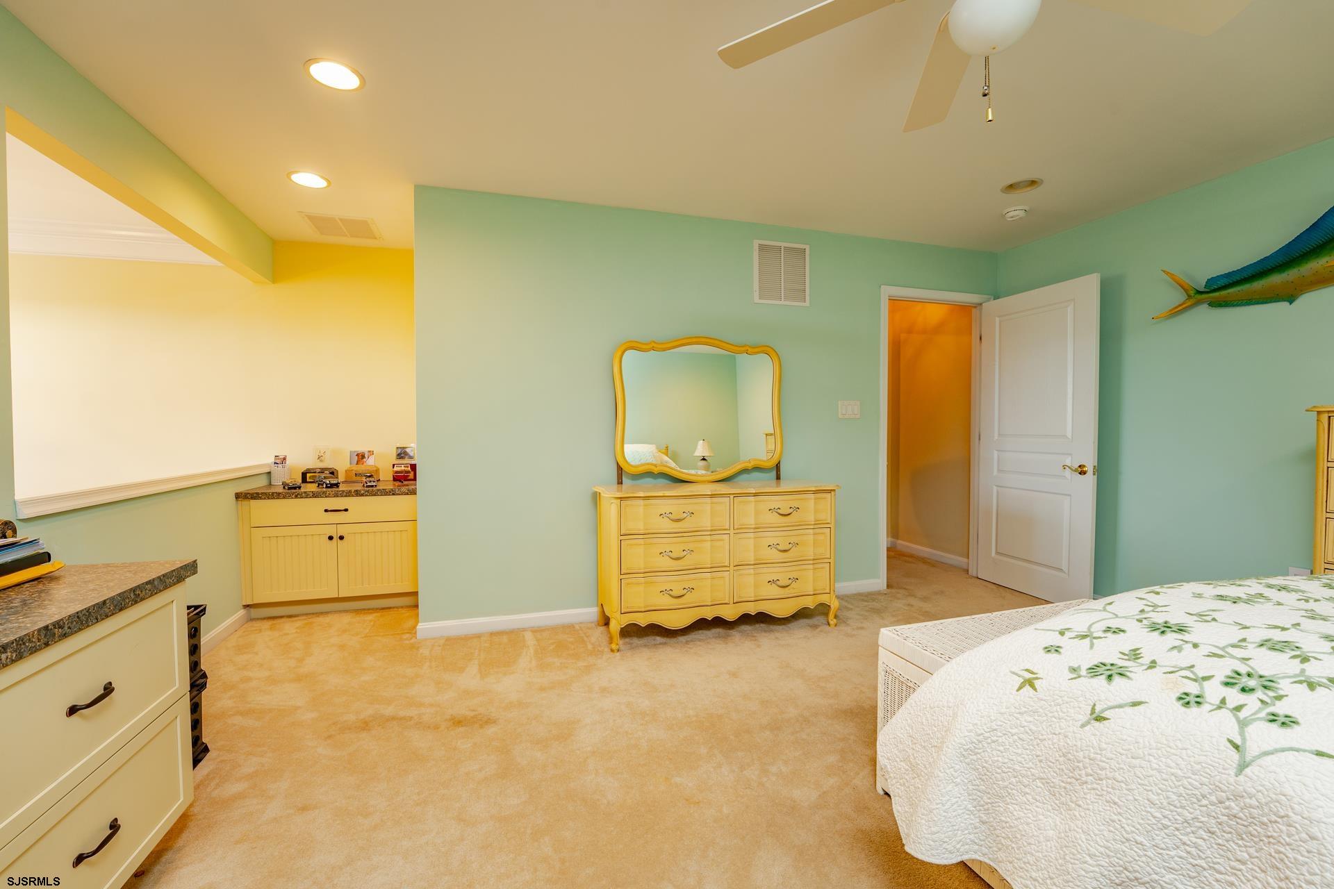 1731 Highway 9, Unit 28 Ocean View, NJ 08230 - Photo 29 of 41 a bedroom with a bed and cabinets