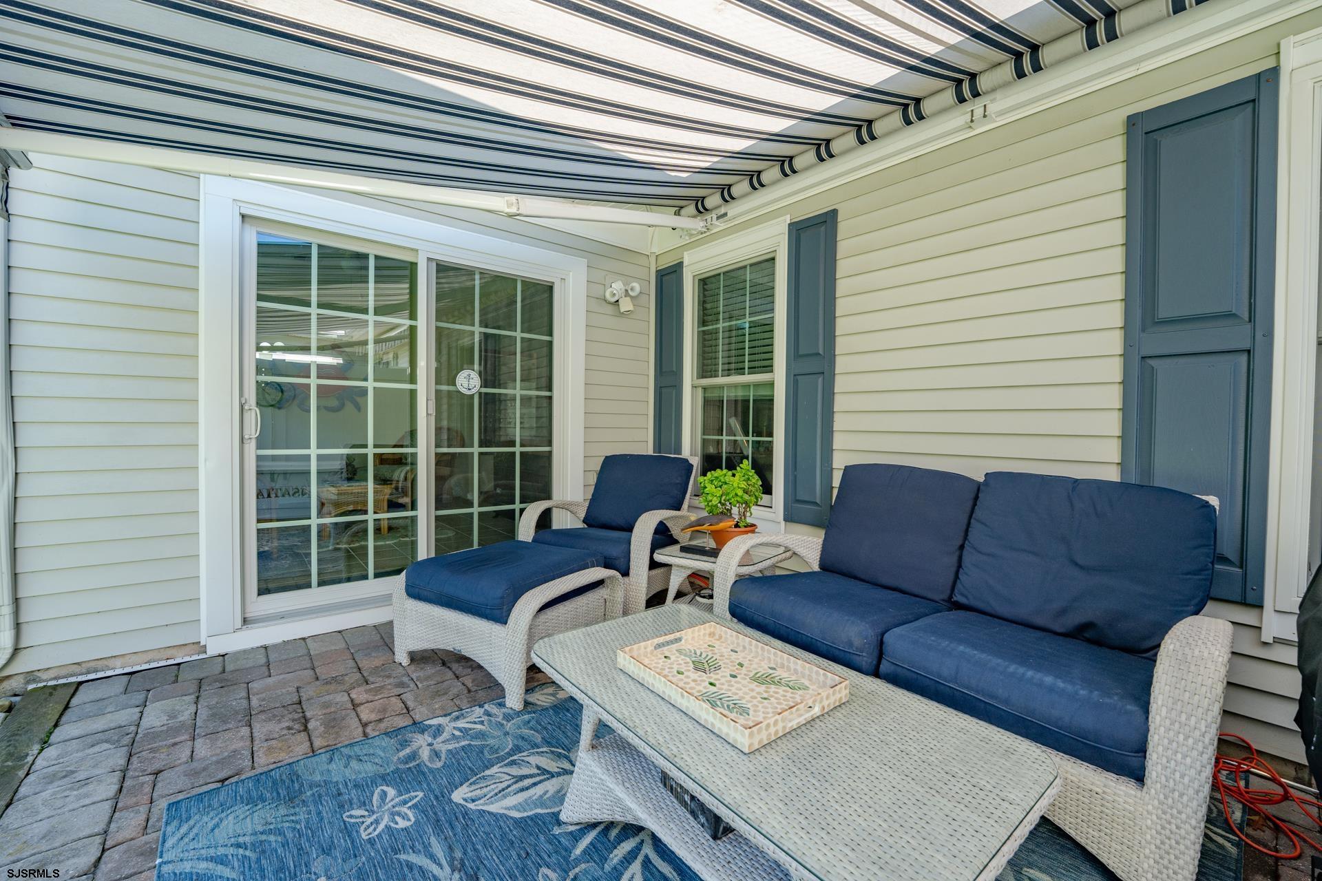 1731 Highway 9, Unit 28 Ocean View, NJ 08230 - Photo 6 of 41 a view of a patio with couches and a dining table with wooden floor