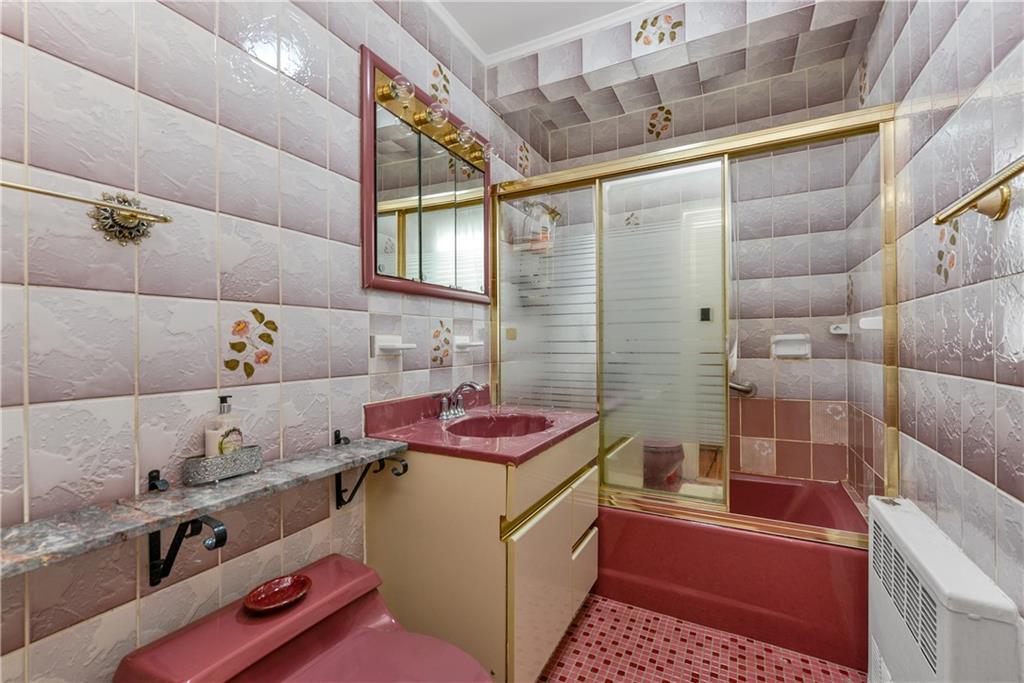 4203 Avenue I Brooklyn, NY 11210 - Photo 13 of 19 a bathroom with a granite countertop bathtub sink vanity and toilet