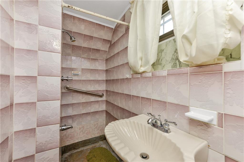 4203 Avenue I Brooklyn, NY 11210 - Photo 14 of 19 a bathroom with a sink and a mirror