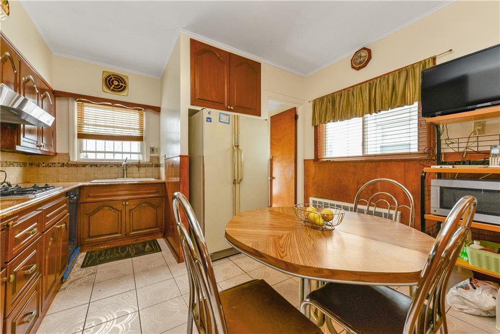 4203 Avenue I Brooklyn, NY 11210 - Photo 8 of 19 a kitchen with a table chairs sink and microwave
