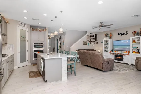 a kitchen with sink stove and cabinets