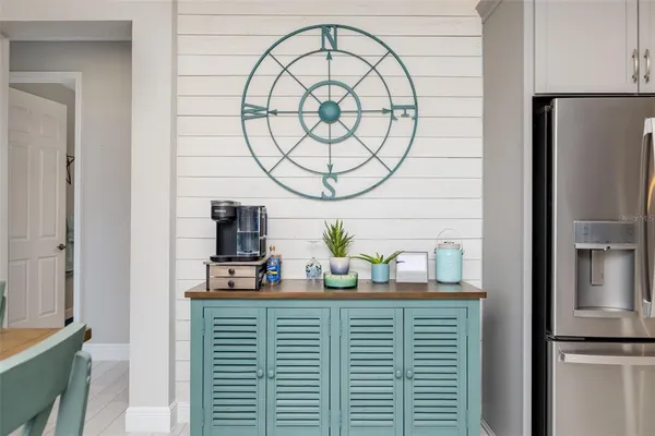a kitchen with a refrigerator and a stove