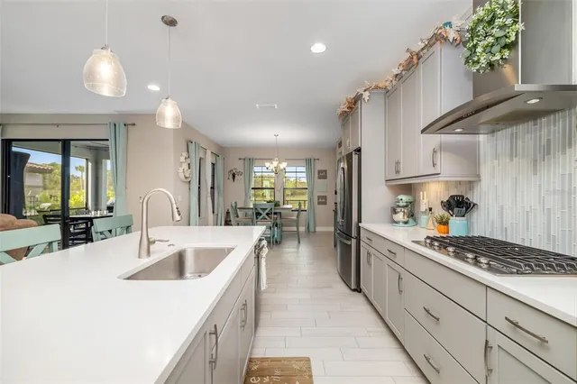 a view of a dining room with furniture large windows and wooden floor
