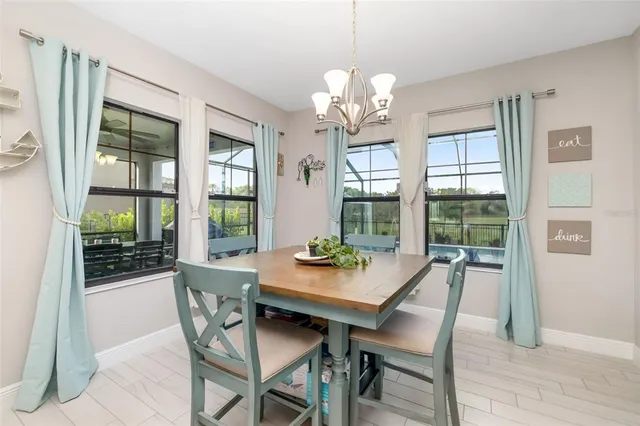 a kitchen with white cabinets and black appliances
