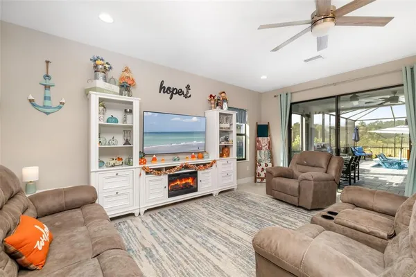 a living room with furniture and a glass door