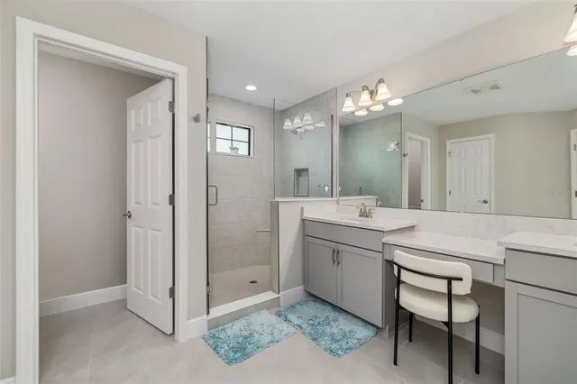 a bathroom with a sink vanity and a mirror