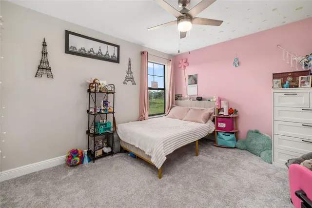 a view of a house with pool and chairs
