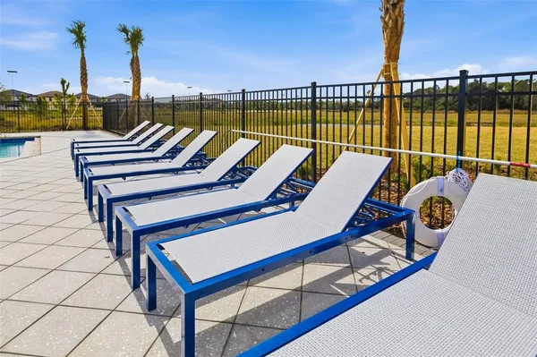 a swimming pool with outdoor seating and yard