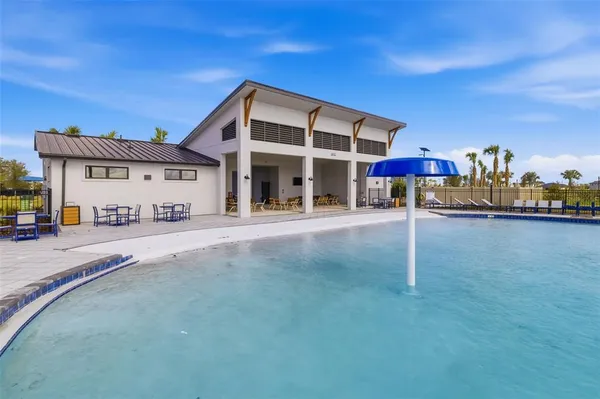 a view of a swimming pool with a outdoor seating