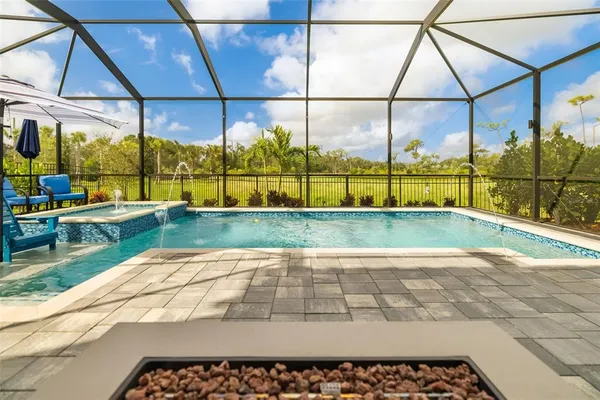 a hallway with painting and a chandelier