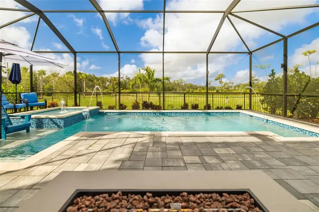 a hallway with painting and a chandelier