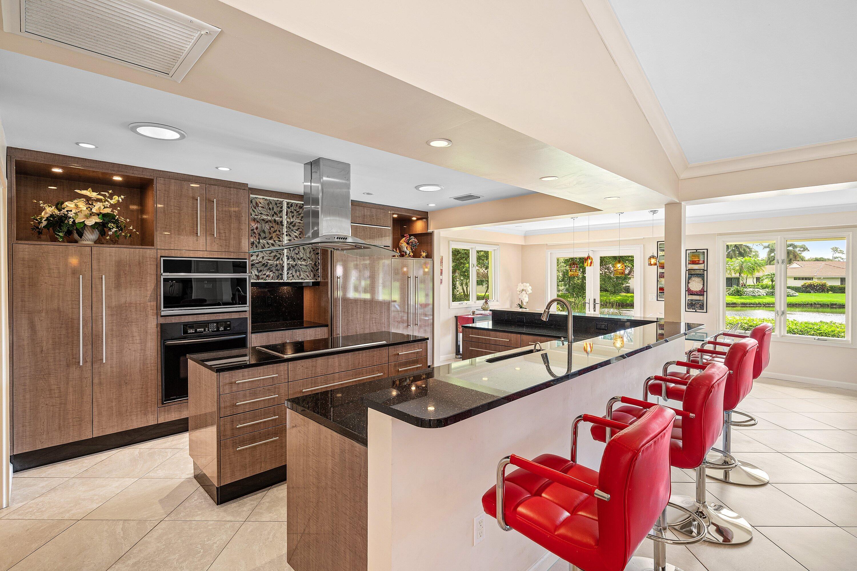 4365 Shell Drake Lane Boynton Beach, FL 33436 - Photo 4 of 56 a kitchen with stainless steel appliances granite countertop a stove and a refrigerator