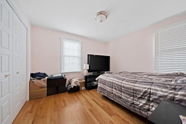 a bedroom with a bed and a television