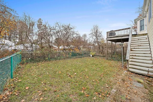 a view of a yard with plants and trees