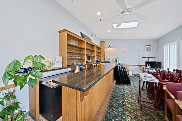 a dining room with furniture and a potted plant