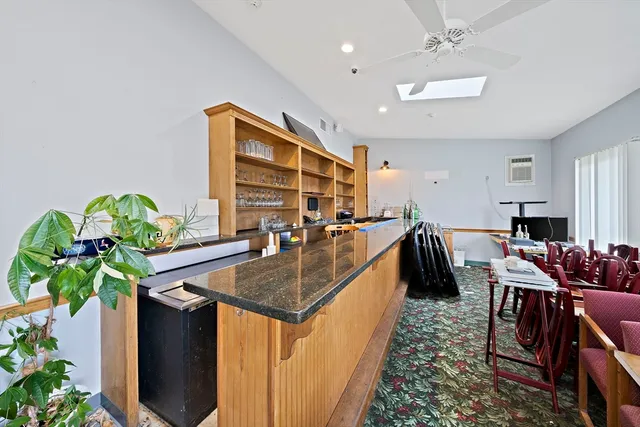 a dining room with furniture and a potted plant