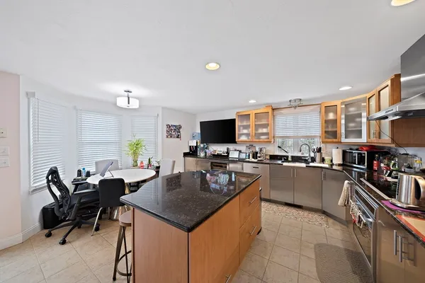 a kitchen with counter top space appliances and a center island