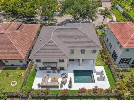 an aerial view of a house with swimming pool