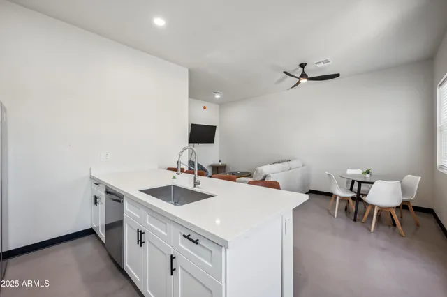 a view of a kitchen area with furniture and wooden floor