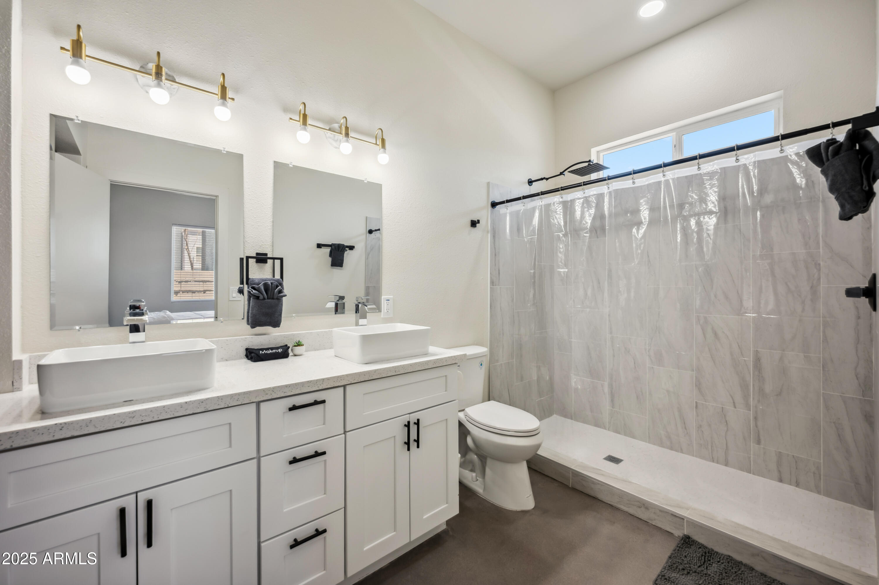 4136 North 11th Street Phoenix, AZ 85014 - Photo 14 of 33 a bathroom with a double vanity sink toilet and shower