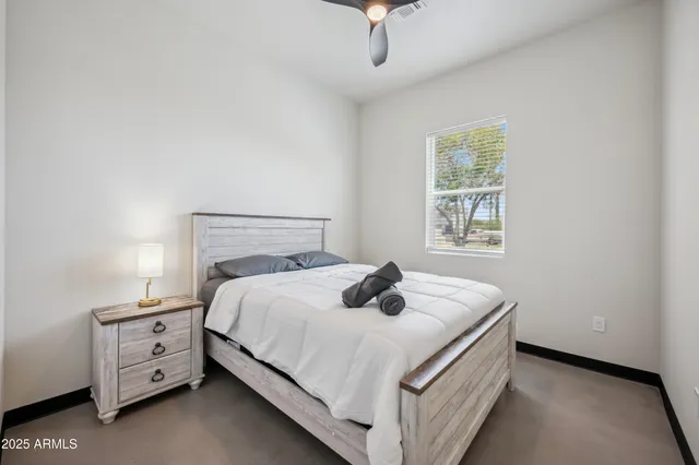 a bedroom with a bed and a window