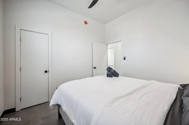 a bedroom with a bed and cabinets