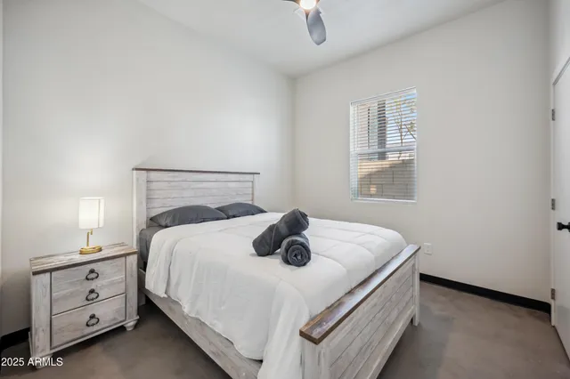 a bedroom with a bed and a window