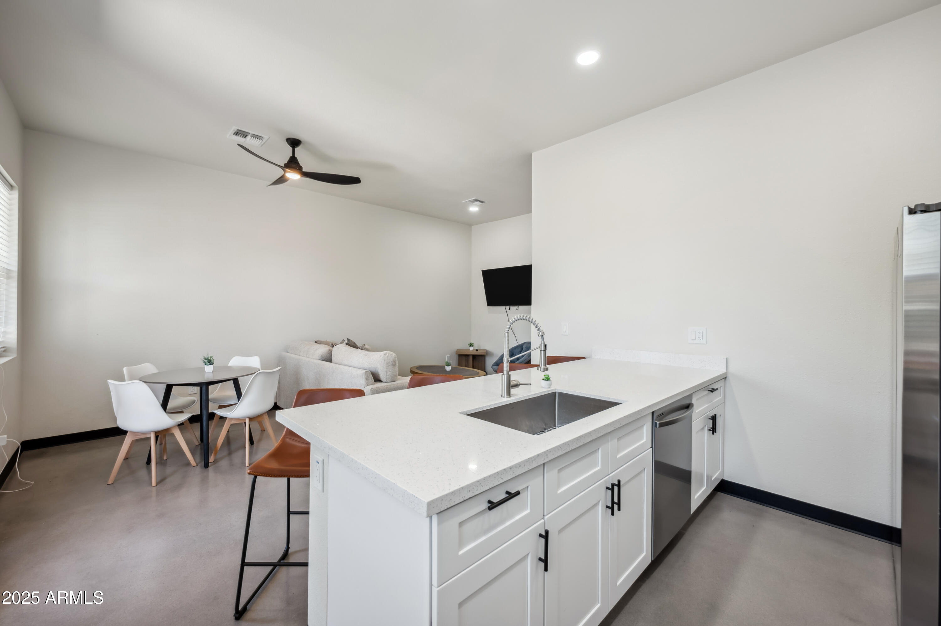 4136 North 11th Street Phoenix, AZ 85014 - Photo 4 of 33 a kitchen with a sink a table and chairs