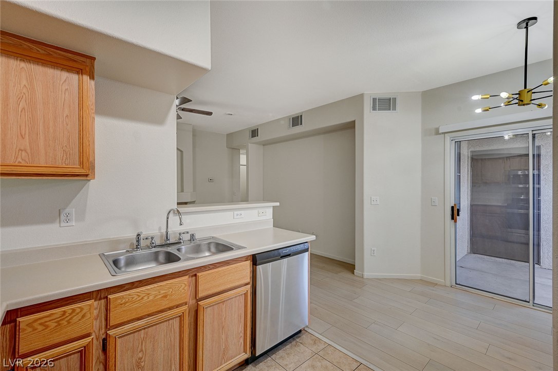 9050 West Warm Springs Road, Unit 1147 Las Vegas, NV 89148 - Photo 16 of 36 A functional kitchen provides ample counter space, a double sink, and a stainless steel dishwasher.