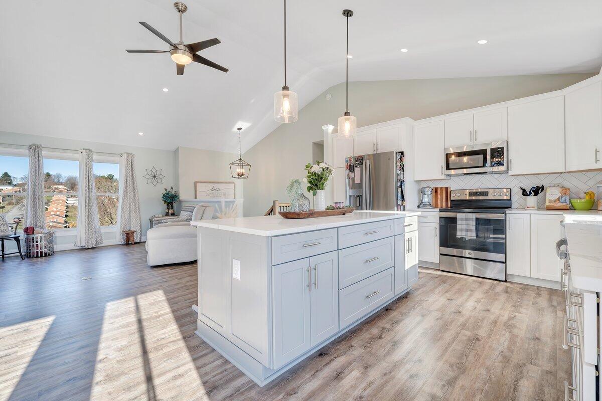 1685 Mountain View Road Vinton, VA 24179 - Photo 15 of 43 a large kitchen with stainless steel appliances kitchen island granite countertop a large center island a stove a refrigerator a sink and white cabinets