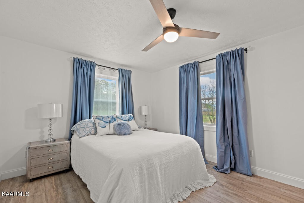 403 Wells Spring Road Dandridge, TN 37725 - Photo 14 of 24 a bedroom with a bed and a chandelier