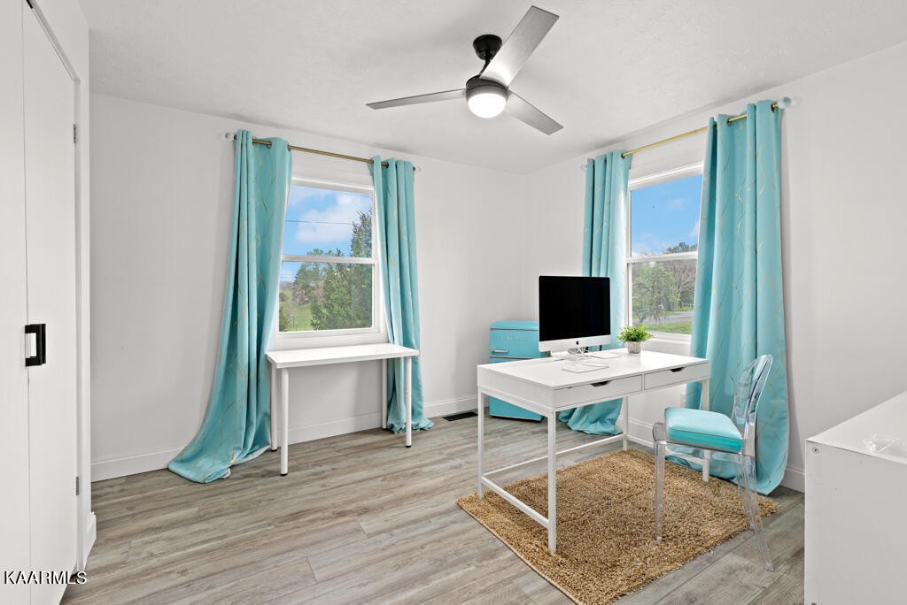 403 Wells Spring Road Dandridge, TN 37725 - Photo 16 of 24 a work room with wooden floor a flat screen tv and a window