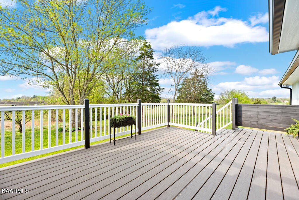 403 Wells Spring Road Dandridge, TN 37725 - Photo 19 of 24 a view of a wooden deck and a yard