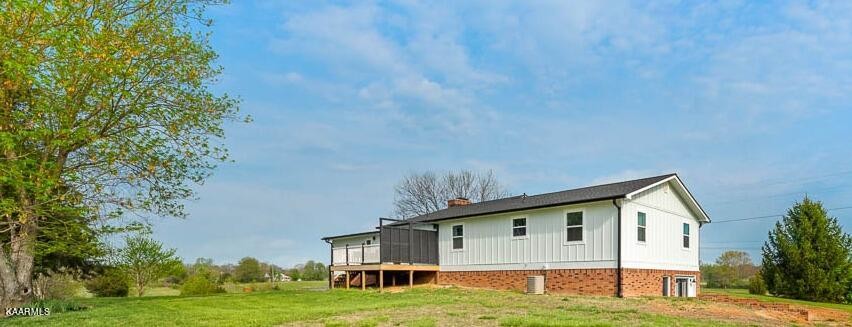 403 Wells Spring Road Dandridge, TN 37725 - Photo 21 of 24 a view of a white house with a big yard and large trees