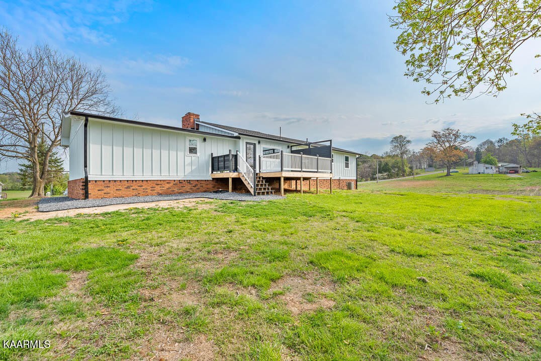 403 Wells Spring Road Dandridge, TN 37725 - Photo 22 of 24 a view of a house with a yard and sitting area