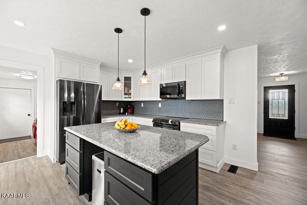 403 Wells Spring Road Dandridge, TN 37725 - Photo 9 of 24 a kitchen with stainless steel appliances granite countertop a sink a stove and refrigerator
