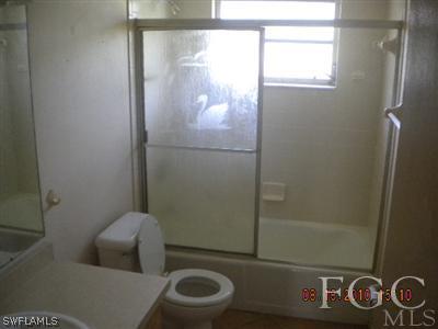 2308 Lotus Road Fort Myers, FL 33905 - Photo 6 of 8 a bathroom with a toilet and a shower